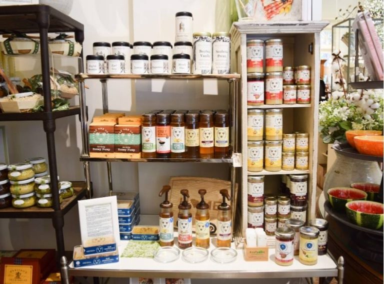 Display of Bear Food snacks and Country Home Creations gourmet mixes on shelves inside a specialty store.